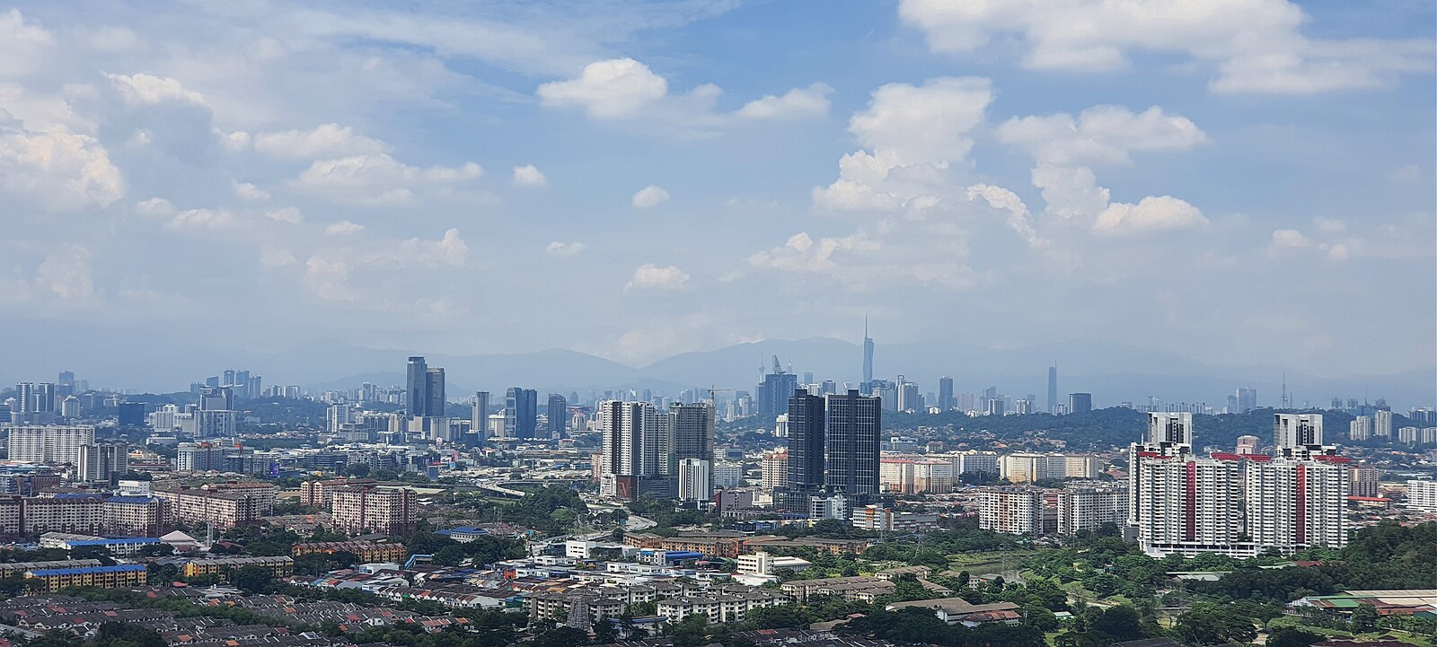 Kuala Lumpur skyline with Petronas Towers and KL Tower seen from Bandar Sunway, Malaysia
